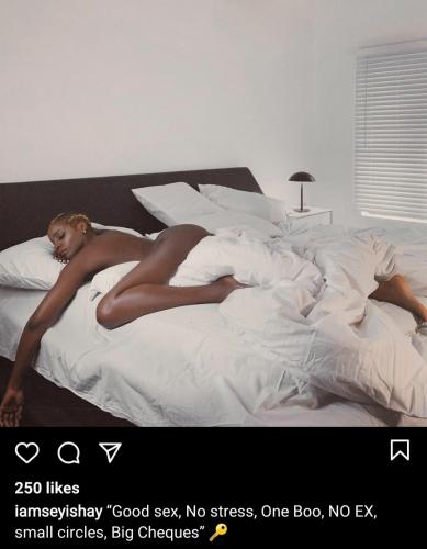 Seyi Shay poses in bed...