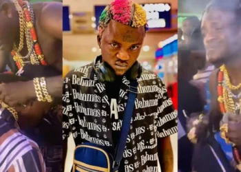 Portable distributes gold necklaces purchased on his U.S. tour to record label artists at Lagos bar